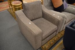 A modern grey upholstered armchair.