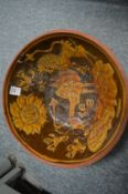 Large slip glaze decorated bowl depicting animals and birds.