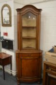 Continental style walnut standing corner cabinet.