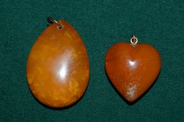 Two amber pendants.