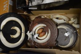 Boars tusks mounted as trophies.