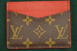 A Louis Vuitton card case.