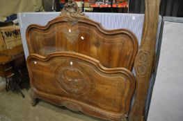 A French carved walnut bedframe, 4ft 6