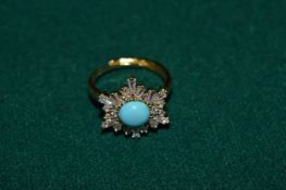 A decorative gilt metal ring set with natural turquoise and CZ.