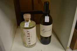 Bottle of gin and a bottle of wine.