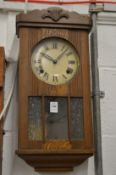An oak cased wall clock.