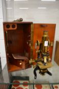 A good brass microscope in original mahogany case with accessories.