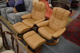 A pair of Ekornes tan leather upholstered swivel reclining armchairs with footstools.