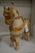 Terracotta pottery model of a horse with white wash body and slip glazed decoration.