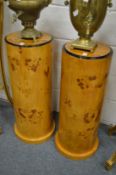 A pair of Art Deco style blonde wood circular pedestals.