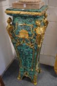 A large and impressive pair of faux malachite and ormolu mounted pedestals, 123cm high.
