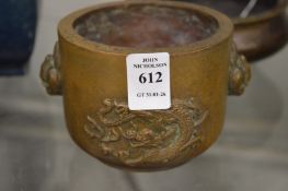 A Chinese bronze censer cast with a dragon.