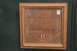 A sampler, framed and glazed.