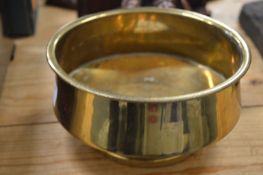 Circular brass bowl.