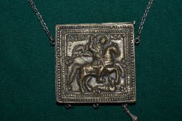 A religious pendant and chain.