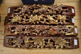 A set of four Chinese carved wood gilded and painted wall brackets depicting birds amongst foliage.