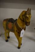 An Indian carved wood and decoratively painted model of a standing horse.