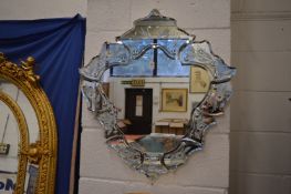 A Venetian style decorative mirror etched with swans and flowers (damage to top).