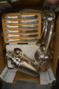 A cased set of six silver handled butter knives, a cocktail shaker, lemon squeezer and other items.