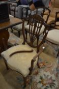 An Edwardian inlaid mahogany shield back elbow chair (faults) together with three other chairs.