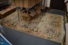 A Chinese beige ground floral decorated rug, 270cm x 180cm.