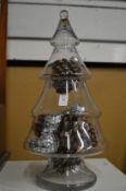 A Christmas tree shaped glass jar.
