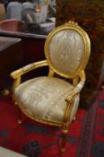 A pair of French style gilt framed armchairs with classical style upholstery.