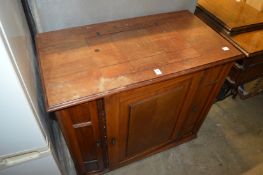 A Singer sewing machine housed in a walnut cabinet.
