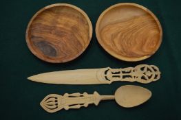 Two turned wood bowls and other wooden items.