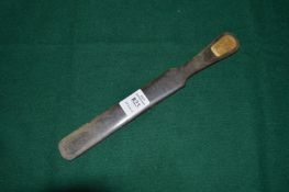 A tortoiseshell letter opener with engraved plaque, dated 1894-1944.