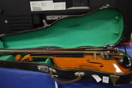 A violin and four various bows.