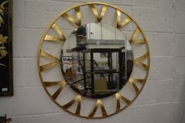 A large decorative gilt metal framed circular wall mirror.