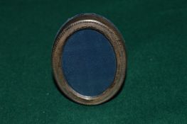 A miniature oval silver photograph frame.