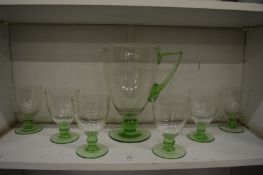 A clear and green glass tinted lemonade set.