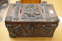 An early wrought iron decorated oak ecclesiastical collection box.