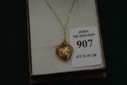A 9ct gold heart shaped pendant and 9ct gold chain.