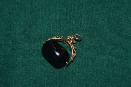 9ct gold spinner fob seal set with three side jet stone.