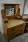 An Arts and Crafts oak dressing chest.