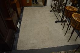 A modern cream woollen rug, 240cm x 170cm.