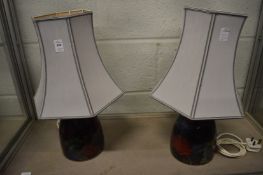 A pair of table lamps and shades.