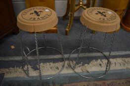 A pair of unusual cork and steel stools modelled as champagne cork closures.
