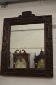 A carved oak framed mirror with crest.