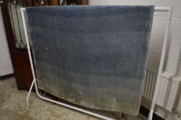 A woollen rug of graduated blue design, 250cm x 160cm.