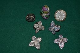A collection of decorative rings and ear clips.