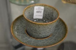 A small Chinese crackle glazed tea bowl and stand.
