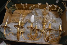 A set of four decorative three branch wall lights.