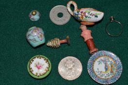 A miniature porcelain saucer and other items.