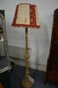 Carved wood standard lamp with decorative shade.
