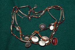 Decorative bead and white metal necklace, possibly silver.