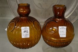 Two amber glass fire grenades.